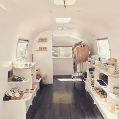 the inside of a small white room with shelves and other items on shelving units