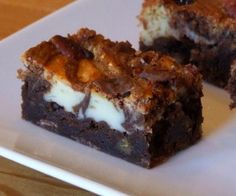 two pieces of dessert sitting on top of a white plate