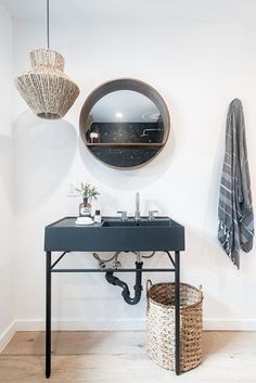 a bathroom with a sink, mirror and towel hanging on the wall next to it