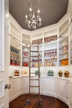 a ladder in the corner of a room with white cabinets and shelves filled with bottles