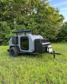 an off road camper trailer parked in the grass