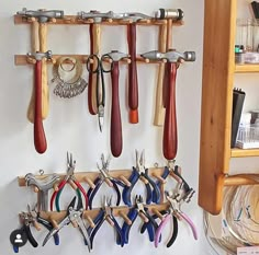 there are many tools hanging on the wall