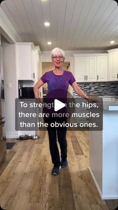 an older woman standing in the middle of a kitchen