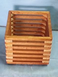 a small wooden basket sitting on top of a tile floor