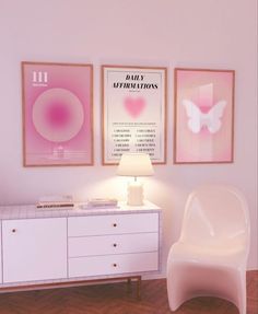 a white chair sitting next to a dresser in a room with posters on the wall