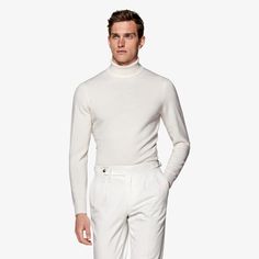 An elegant complement to any seasonal style, this off-white turtleneck is tailored to a slim fit and features a folded turtleneck collar with a ribbed texture. Fitted Elegant Winter White Sweater, Elegant Winter White Turtleneck Top, Elegant Fitted Winter White Sweater, Elegant Winter White Workwear Tops, Elegant Winter White Tops For Workwear, Elegant Off-white Tops For Work, White Formal Sweater For Winter, White Long Sleeve Formal Sweater, Elegant White Sweater For Workwear