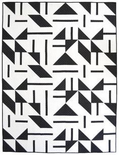 a black and white quilt with arrows on it