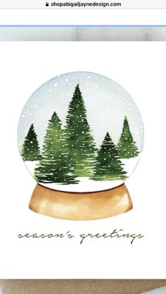 a snow globe with trees in it and the words season's greetings written inside