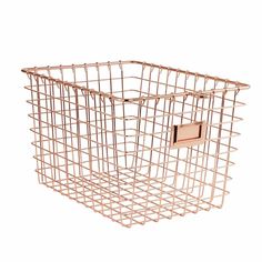 a large metal basket with a tag on it's front and side handles in rose gold