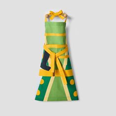 a green and yellow apron hanging on a wall