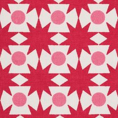 a red and white quilt with pink circles on the center, in an abstract pattern