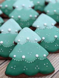 cookies decorated with green and white frosting are on a table