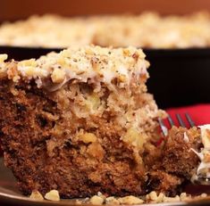 a close up of a piece of cake on a plate with a fork in it