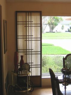 a dining room with sliding glass doors and chairs