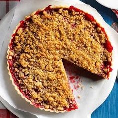 a pie sitting on top of a white plate with a slice missing from it's crust