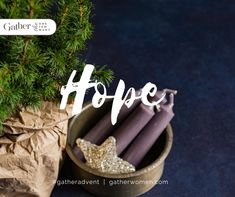 some candles are sitting in a small wooden bowl next to a bag with the word hope written on it