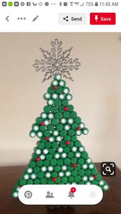 a christmas tree made out of buttons on a wooden table with an instagramr