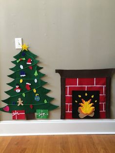 a fireplace decorated with christmas decorations next to a small tree and fire place on the mantle