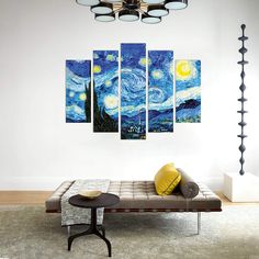 a living room with a couch and paintings on the wall in it's center