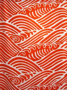 an orange and white pattern with waves on it