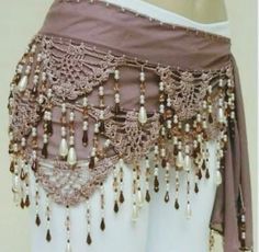 a woman's belly belt with beaded trim and pearls on the bottom,