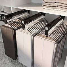 several pieces of luggage are stacked on top of each other in a closet with white shelving