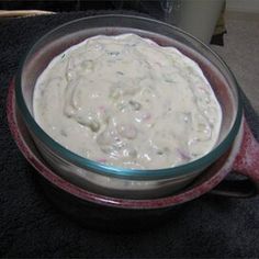 a bowl filled with white sauce sitting on top of a table