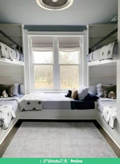 a bedroom with bunk beds and stuffed animals on the floor in front of a window