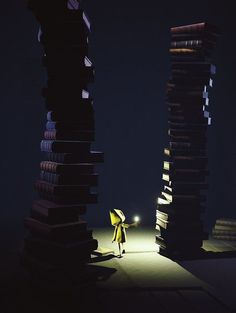 a person standing in front of stacks of books with a flashlight on their head and arms