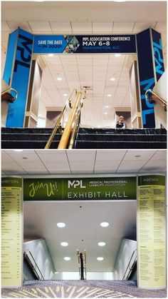 an escalator in the middle of a building with signs above and below it