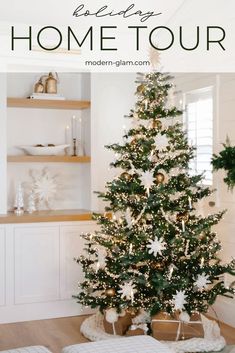 a white christmas tree with snowflakes on it in the corner of a room