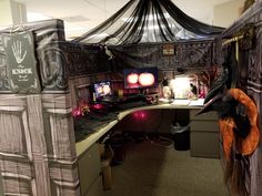 an office decorated for halloween with decorations on the desk and in the background is a drapes