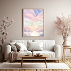 a living room with a white couch and coffee table in front of a painting on the wall