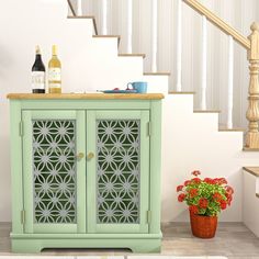 a green cabinet sitting next to a stair case