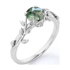 a white gold ring with a green stone in the center and leaves on it's sides