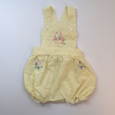 This is a cute vintage baby girl's romper perfect for summertime fun! The fabric is yellow with flowers embroidered on the chest and hips. There are crisscross straps at the back. It is in very good vintage condition. Size 9 months Sleeveless Yellow Cotton Bubble Romper, Yellow Cotton Bubble Romper For Summer, Summer Yellow Cotton Bubble Romper, Yellow Cotton Summer Bubble Romper, Cute Embroidered Bubble Romper For Spring, Yellow Cotton Bubble Romper For Spring, Spring Yellow Cotton Bubble Romper, Cute Yellow Sleeveless Bubble Romper, Cute Sleeveless Yellow Bubble Romper