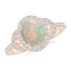 A beautiful oval opal is prong set at the center of this vintage inspired ring. Sparkling round diamonds surround the center stone and cascade down the shoulders of the ring. Crafted in 14k rose gold, this opal halo ring is the perfect blend of a striking design and superior craftsmanship. 14th Wedding Anniversary, Opal Ring Vintage, Vintage Inspired Rings, Halo Ring, Halo Rings, Opal Rings, Round Diamonds, Gemstone Jewelry, Heart Ring