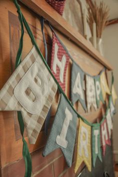 a happy birthday banner hanging from a fireplace