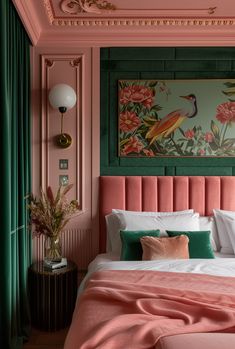 a bedroom with pink and green walls, white bedding, and paintings on the wall