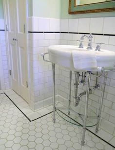 two sinks and mirrors in a bathroom with white tiles on the floor, one is for sale