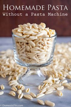 a glass bowl filled with sunflower seeds on top of a blue tablecloth and text reads homemade pasta without a pasta machine