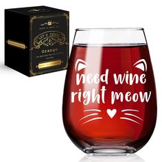 a wine glass with the words need wine right meow on it next to a box