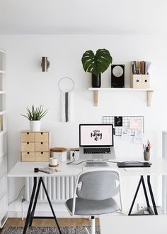 black and white photograph of a desk with a laptop