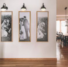 three black and white photos hang on the wall above a wood floored dining room table