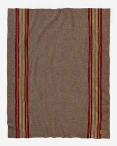 a brown blanket with red, yellow and green stripes on the bottom is laying flat