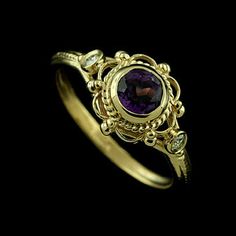 Victorian Amethyst Diamond Bezel Set Vintage Filigree Twisted Design Yellow Gold Engagement Ring Romantic and decorative, Victorian style engagement ring made of 14K yellow gold. Features one round bezel set amethyst surrounded by an open filigree design. Two bezel set small diamonds on either side of the cener stone (.06cttw, G-H color, SI1-SI2 clarity). High polish, smooth sides and edges. Also available with different gemstones. Please contact us for details. SIZES: 4-8 (smaller and larger si Red Garnet Oval Cabochon Ring, Victorian Red Oval Cabochon Jewelry, Vintage Red Oval Rings, Vintage Red Oval Ring, Vintage Red Oval Birthstone Ring, Red Oval Hallmarked Birthstone Ring, Red Oval Birthstone Ring Hallmarked, Victorian Style Engagement Ring, Pink Tourmaline Engagement Ring