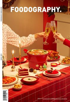 two people toasting wine glasses at a table covered in food