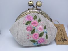 a purse with flowers on it sitting on a table