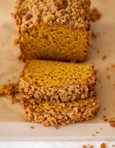 two slices of pumpkin crumb bread sitting on top of a piece of parchment paper