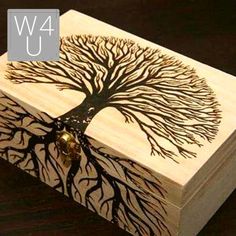 a wooden box with a tree on it